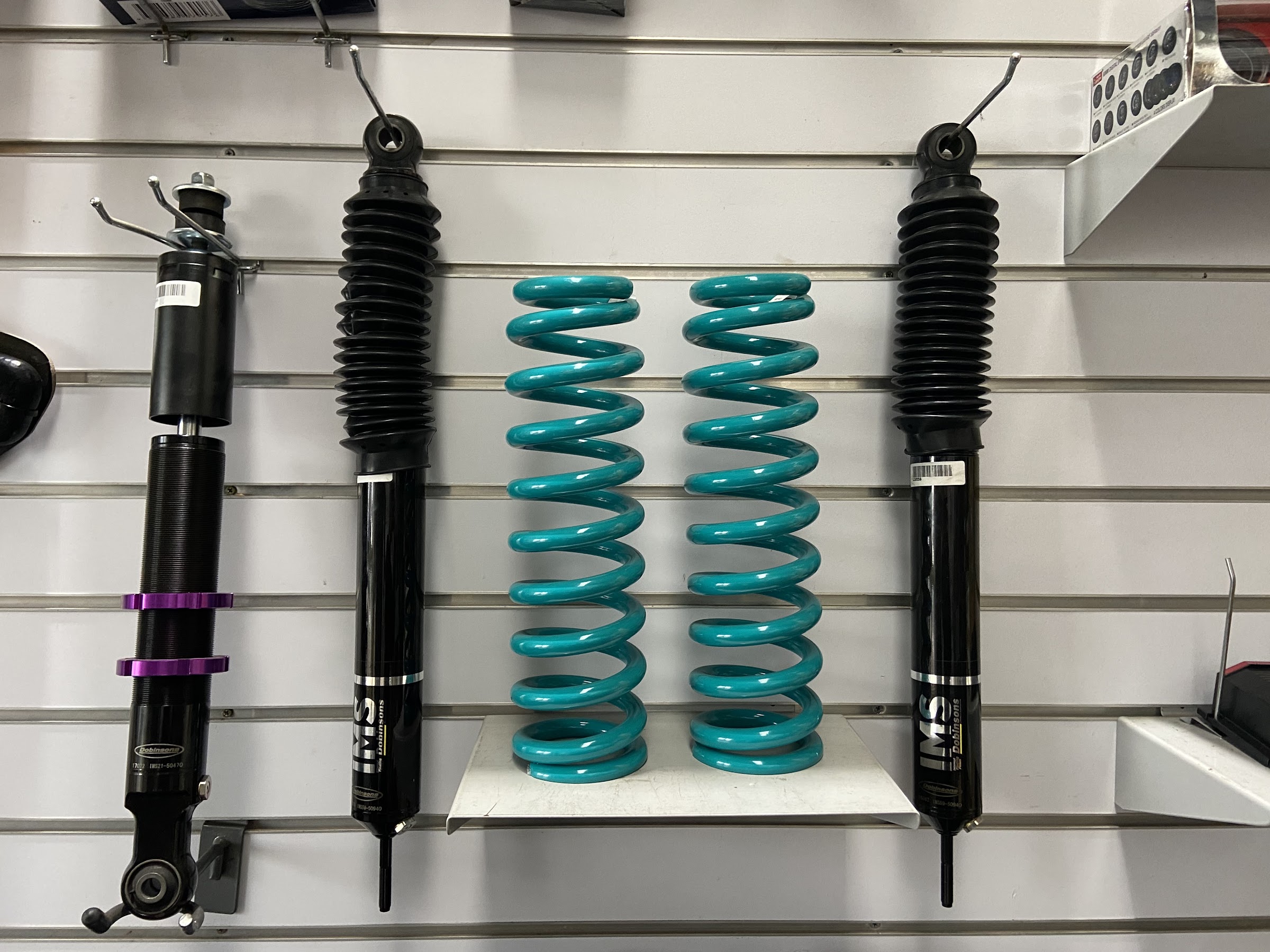 Dobinsons shock absorbers and coil springs displayed on the showroom wall