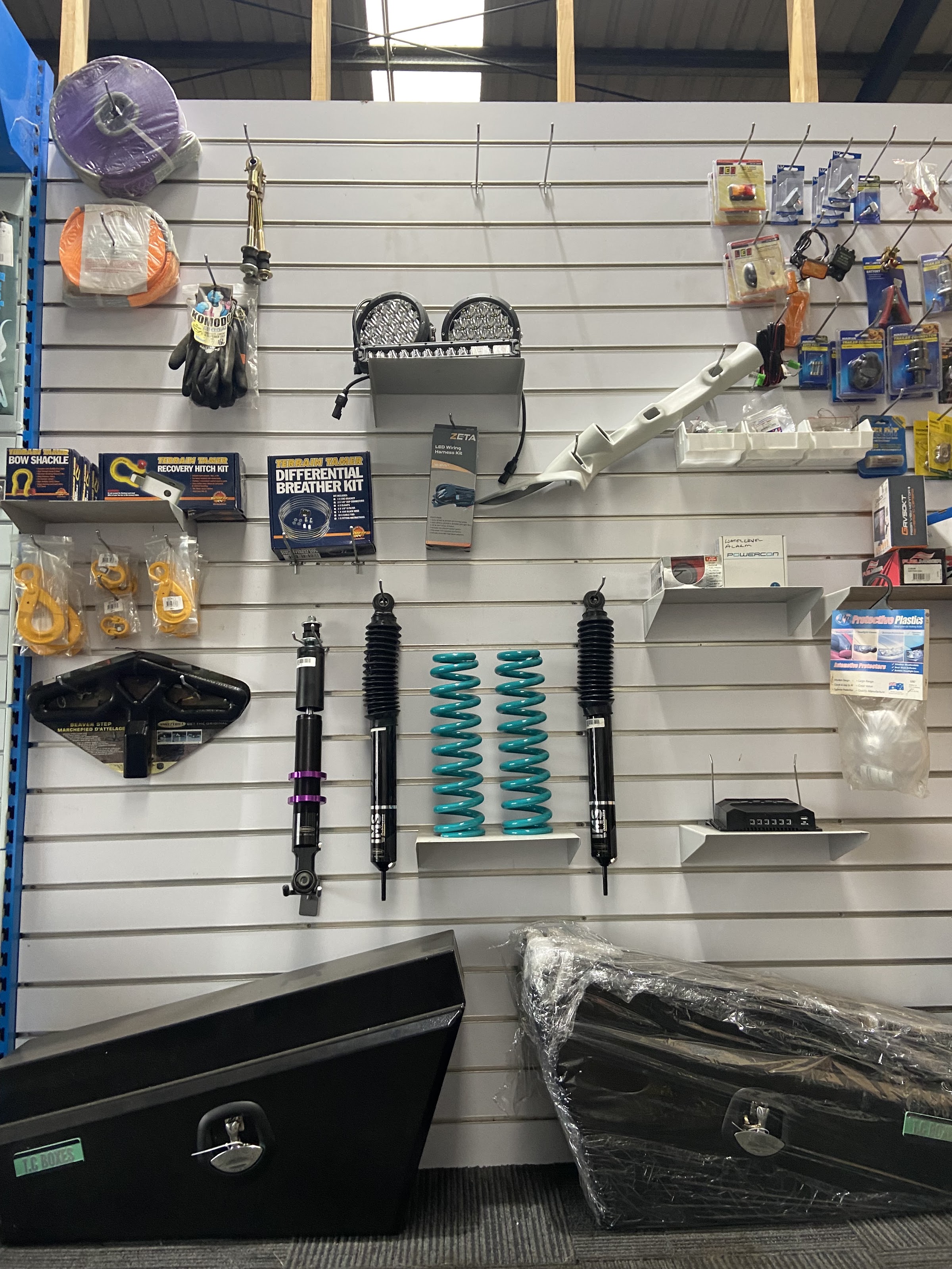 The accessories wall at Portland Off Road, hung with recovery gear, shackles, light bars, suspension and toolboxes